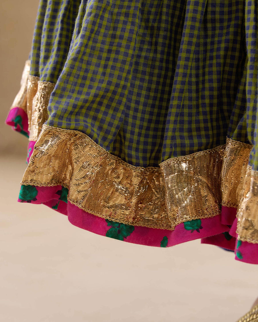 Close-up of the hem of the Kochi Kurta: a band of antique gota on crinkled lime and purple checked cotton.