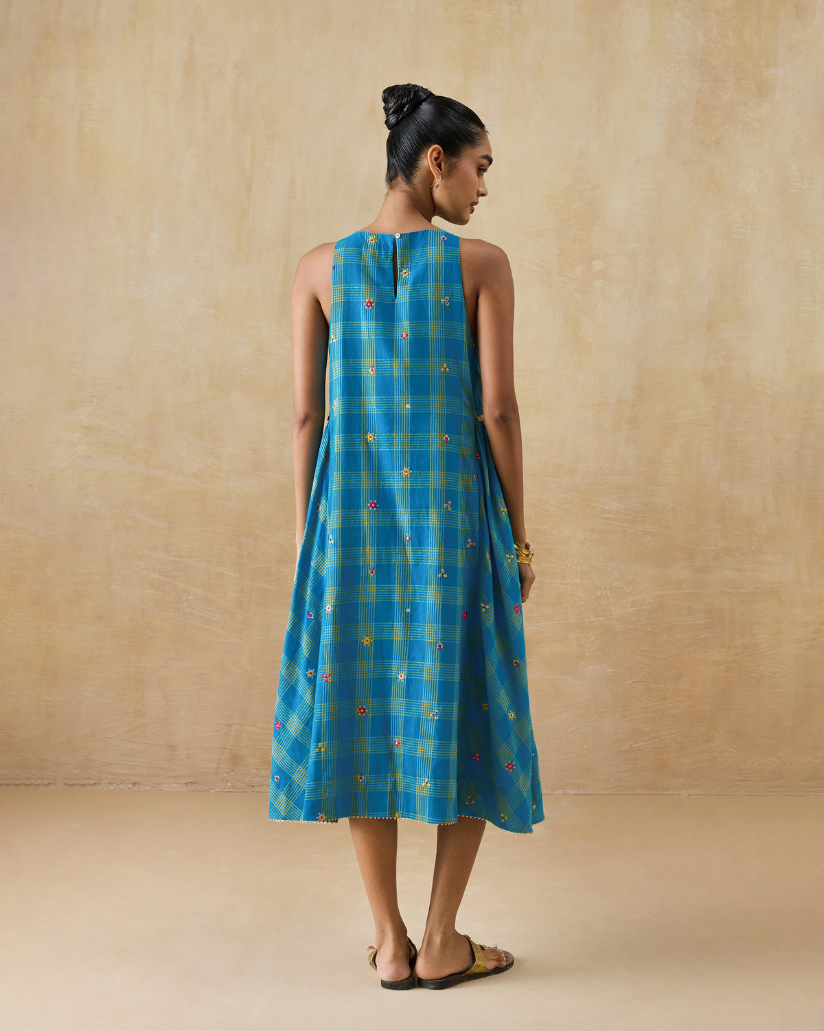 Back of a cerulean check Nimbus dress with a keyhole button closure.