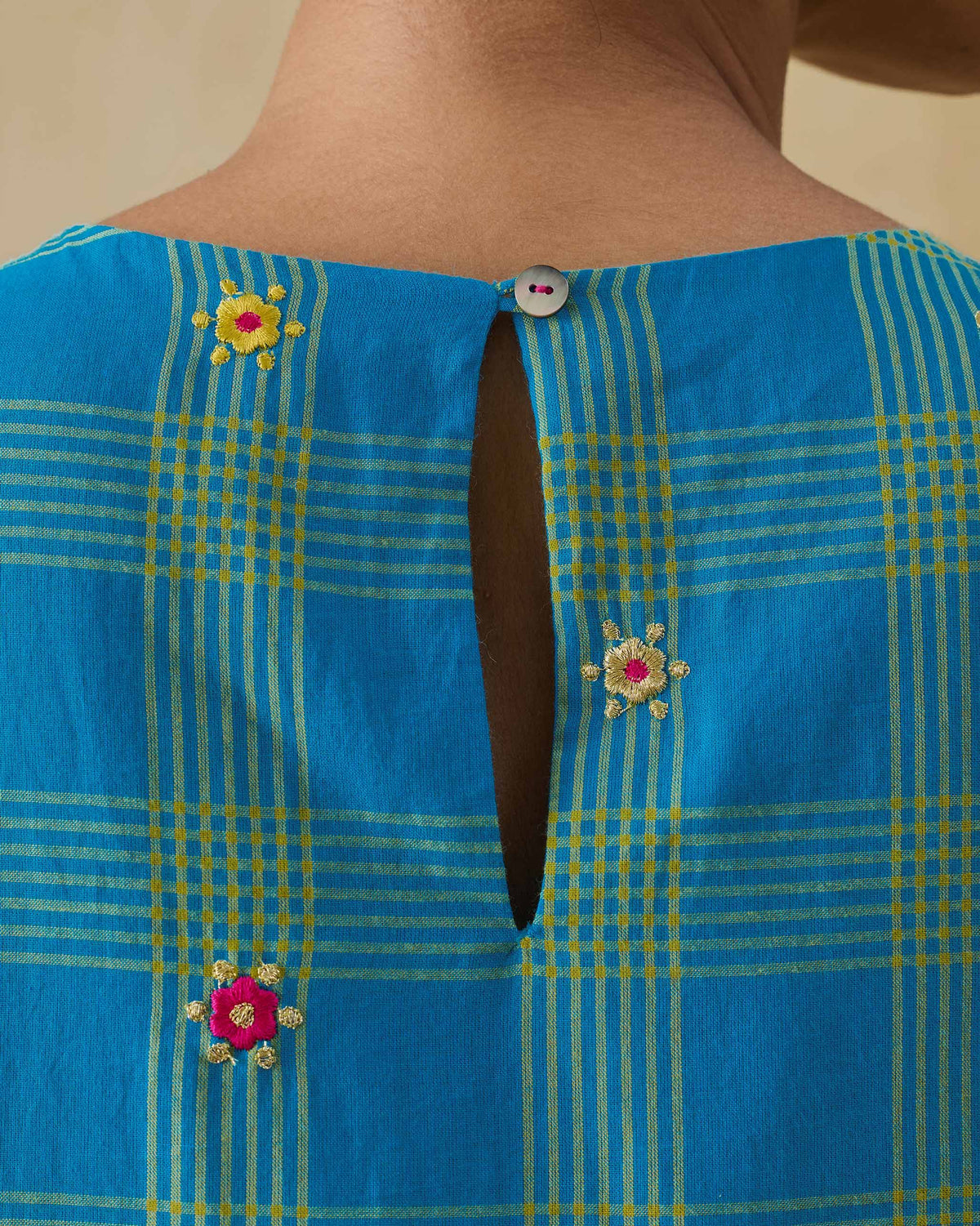 Close-up of the Nimbus dress back keyhole with a button closure.