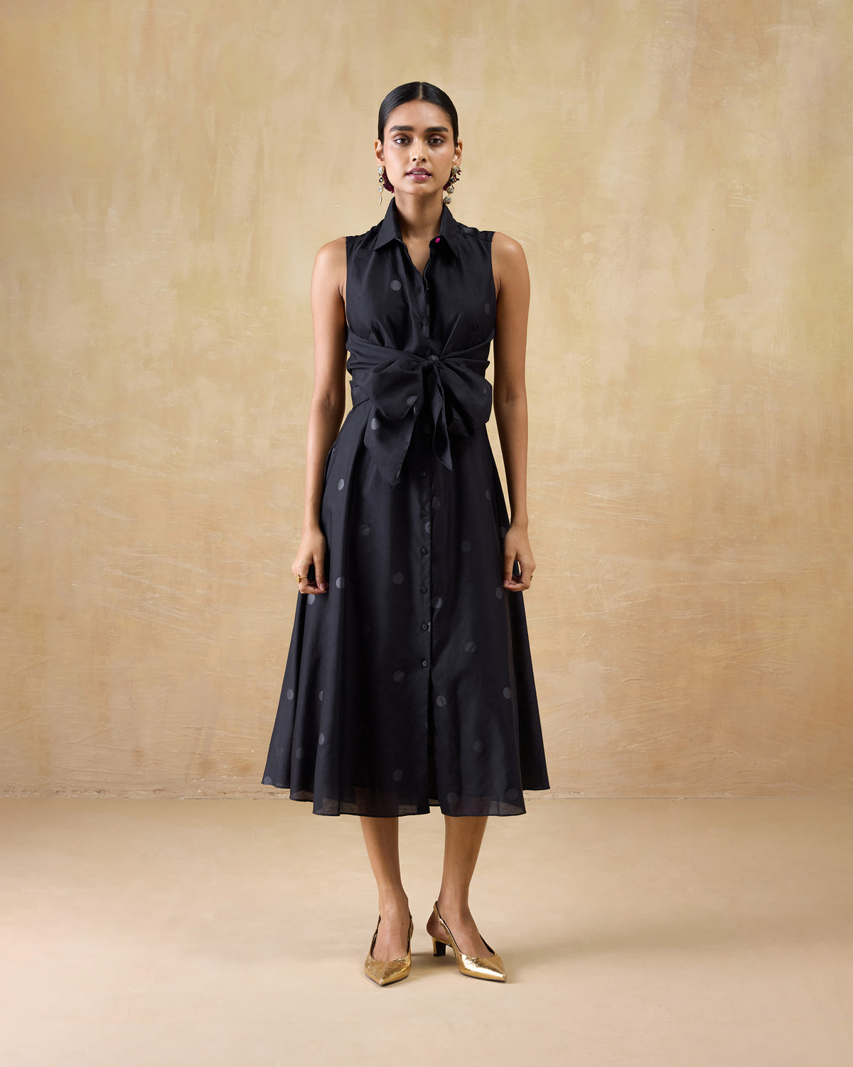 Person wearing a black flared Sonnet dress with a collar.