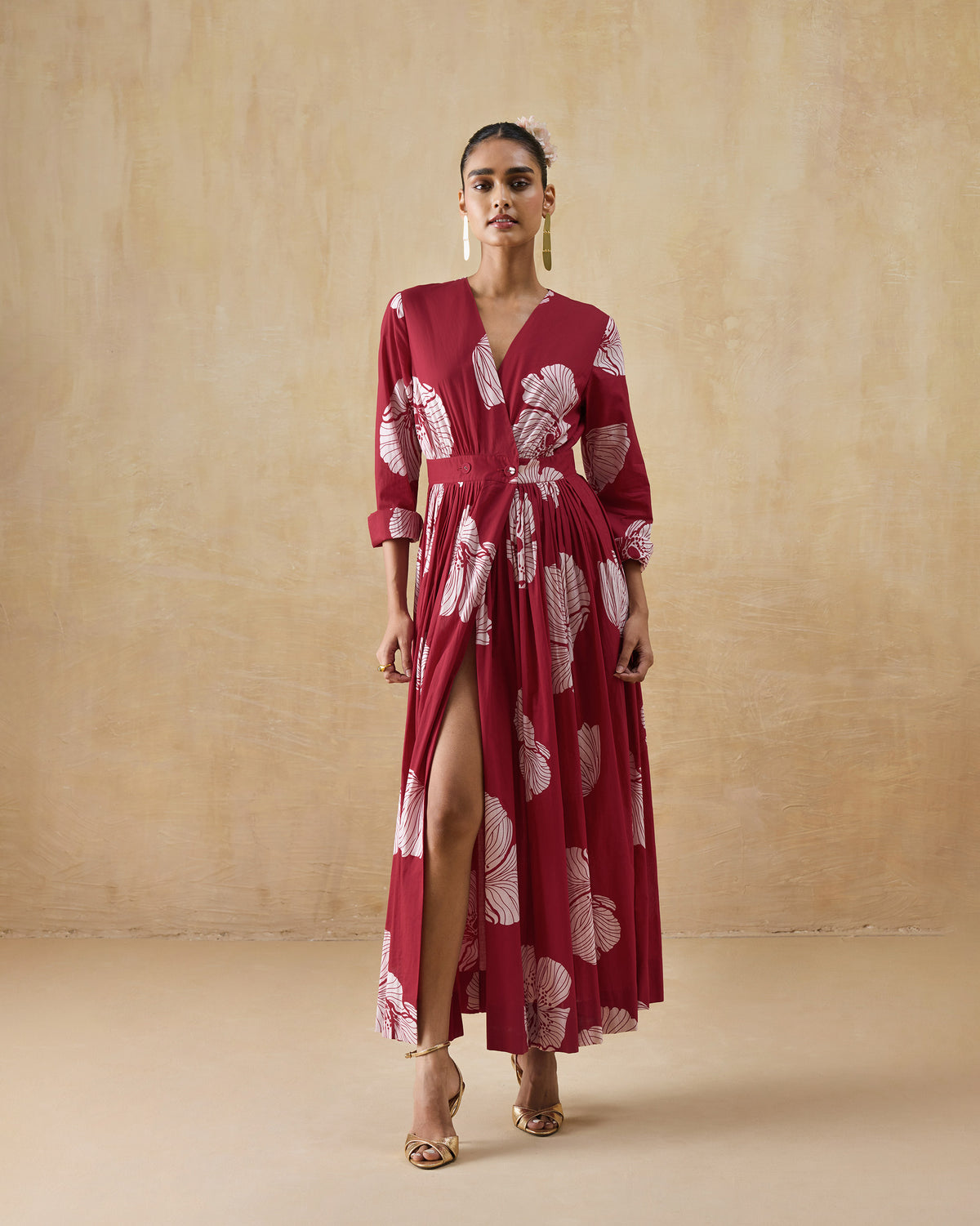 Person wearing a red and ivory Nico dress with a white floral print and flared skirt.