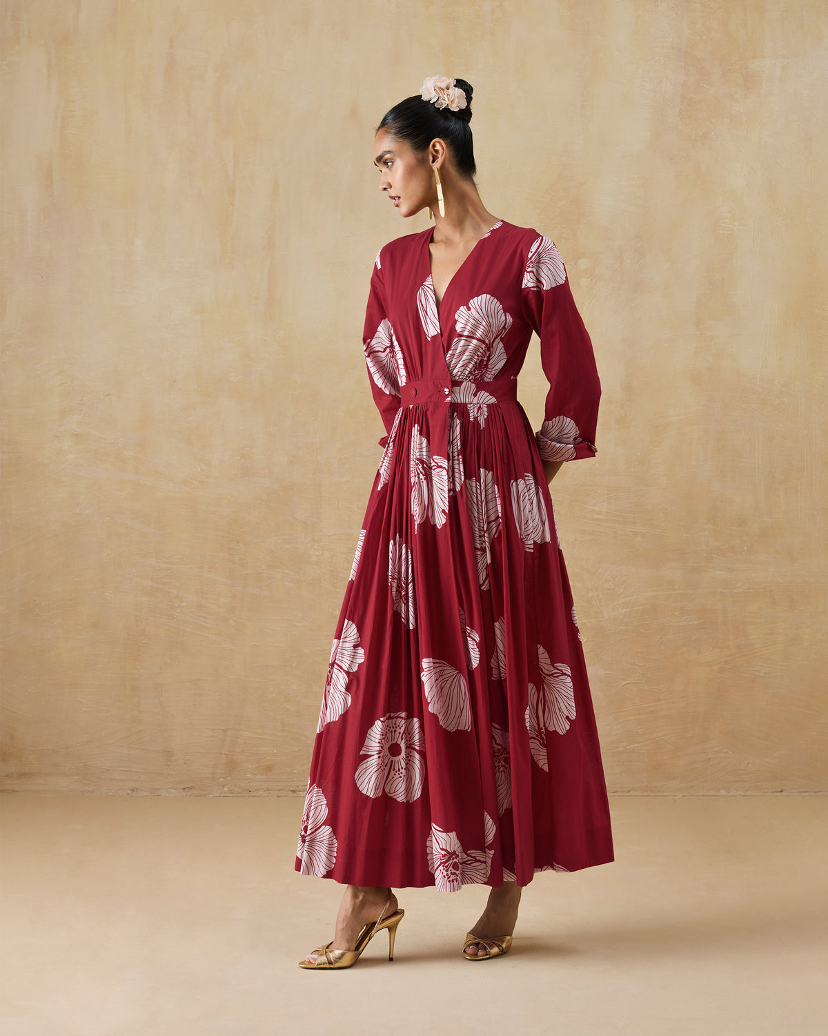 Side view of a red and ivory Nico dress showing the flared maxi silhouette.