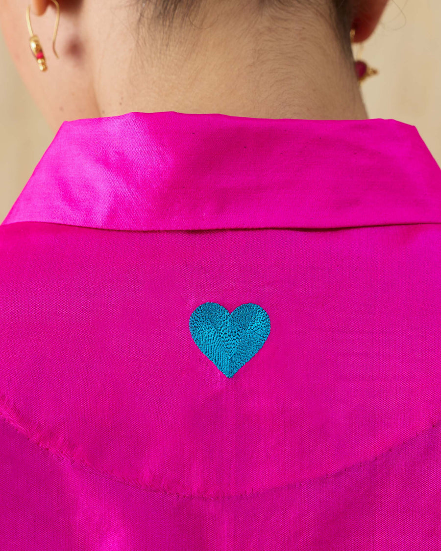 Close-up of the teal heart embroidered below the moon patch on the back of the Boxy Shirt.