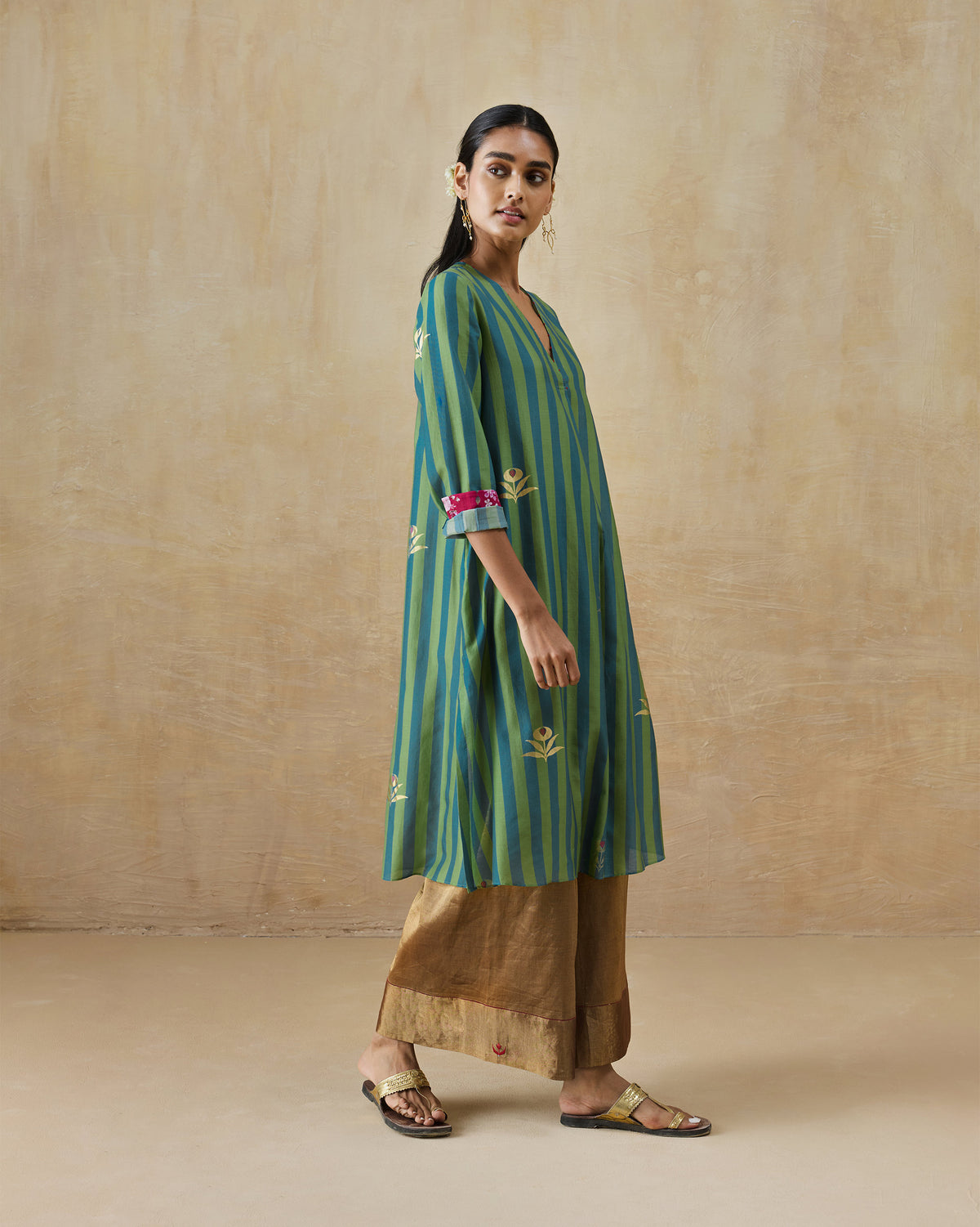 Side view of a green and blue striped Front Pleated kurta with pink cuffs.