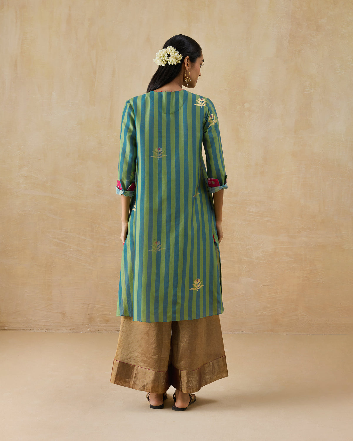 Back of a green and blue striped Front Pleated kurta with gold embroidery.