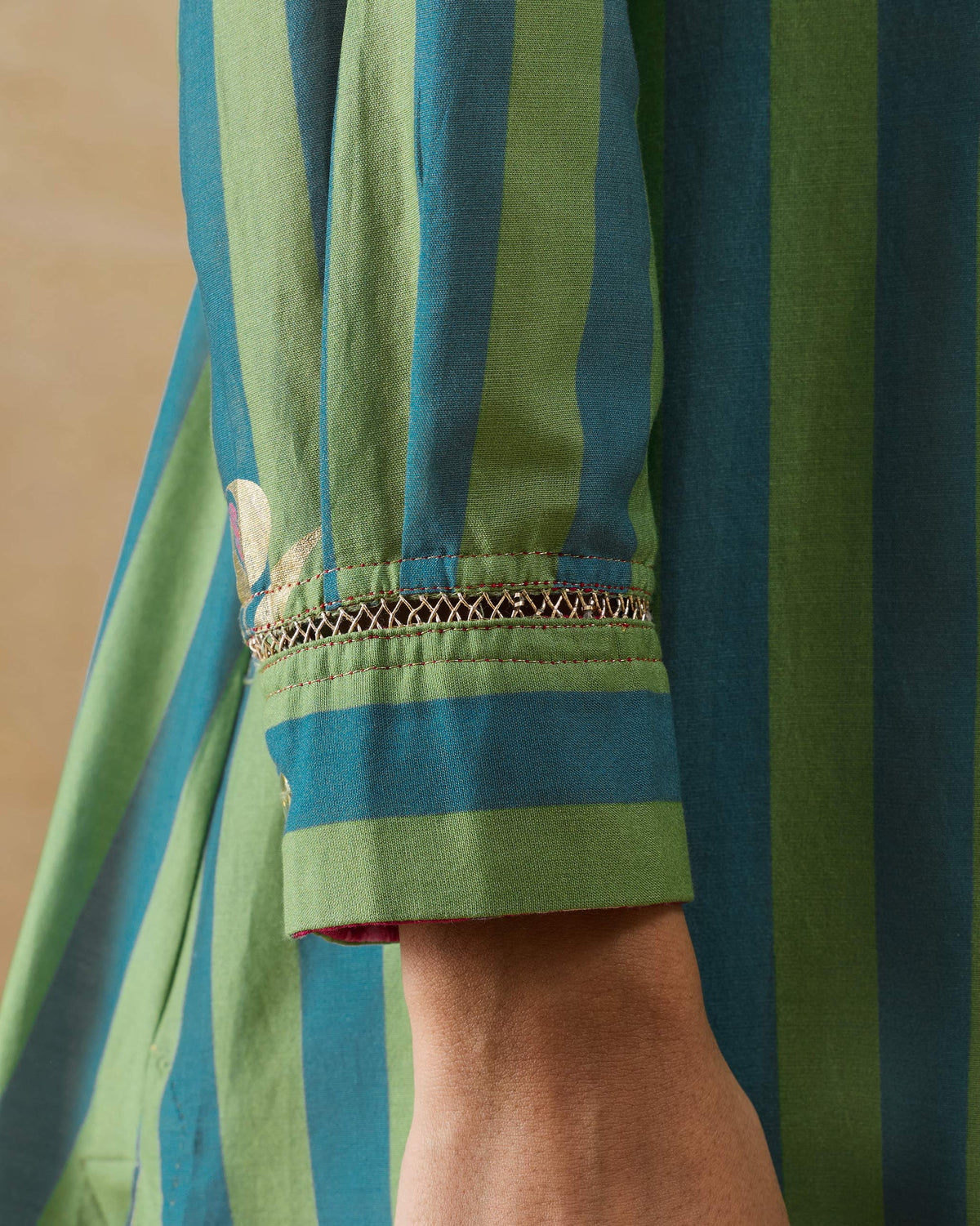Close-up of lace trim and gold motifs on a Front Pleated kurta sleeve.