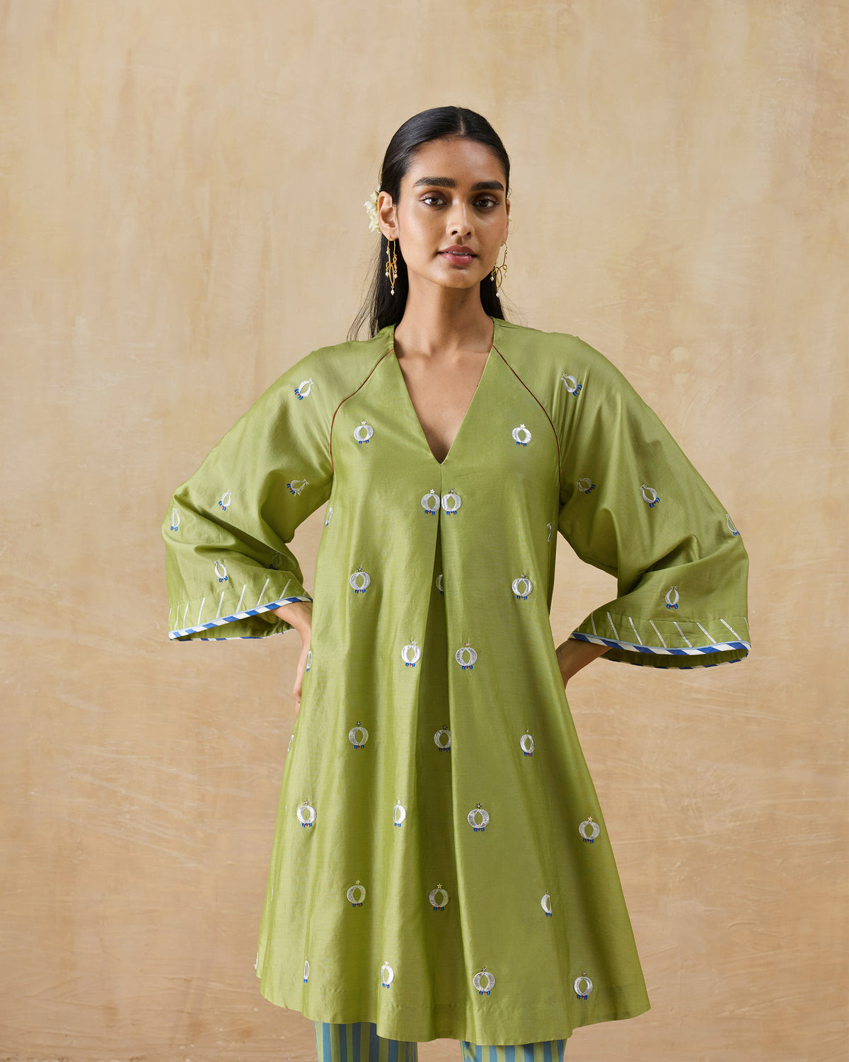 Front of an olive green Revelry kurta with a V-neck and flared sleeves.
