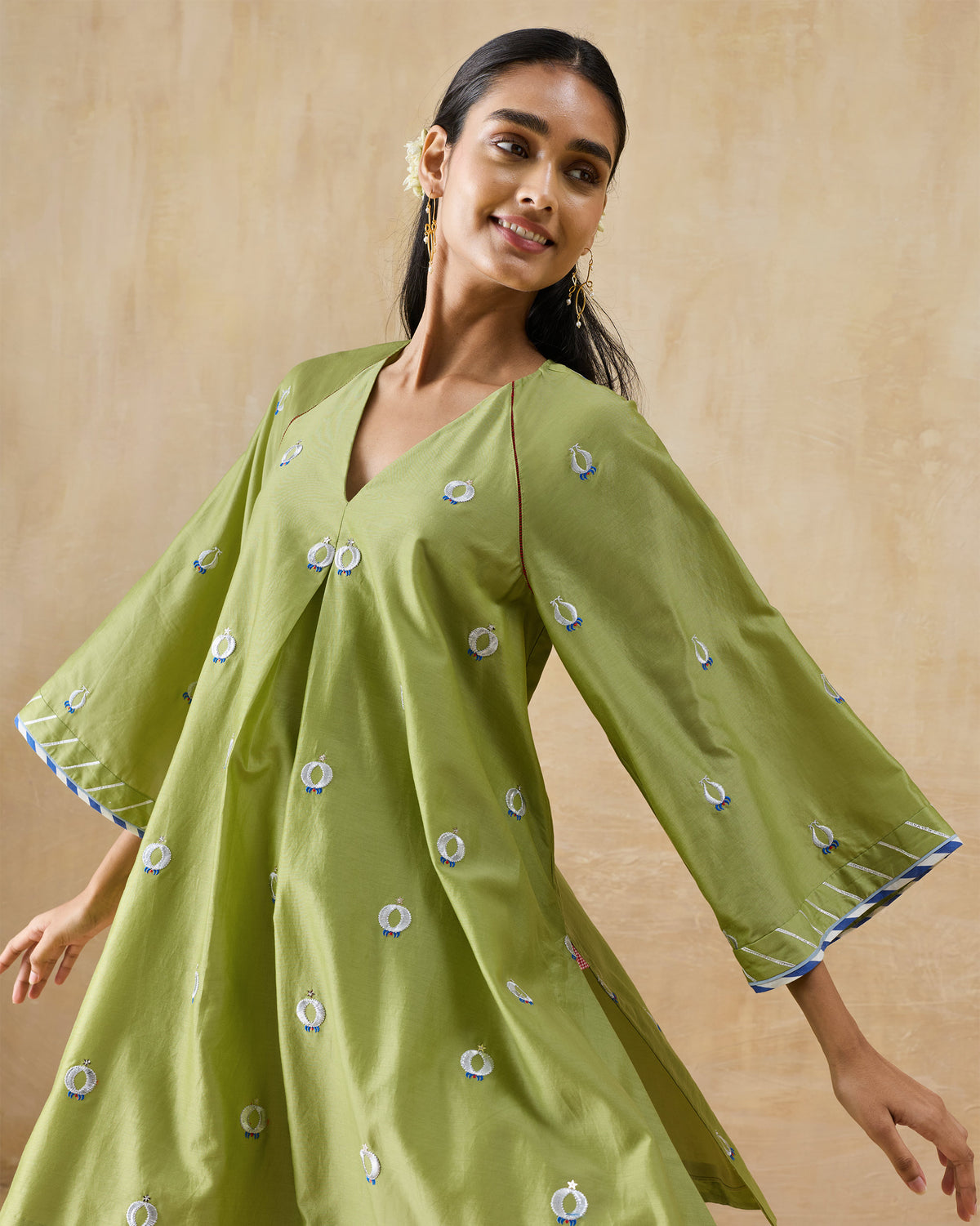 Olive green Revelry kurta with embroidered motifs and blue striped cuffs.