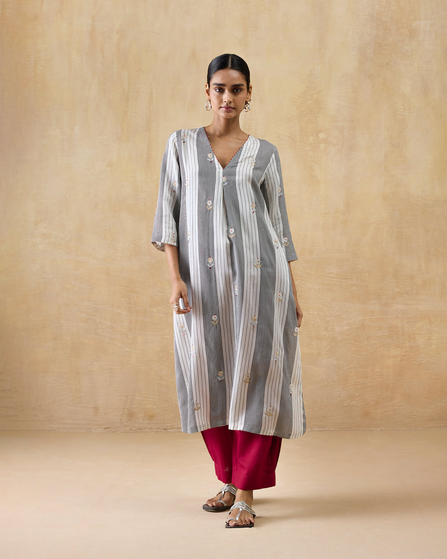 The Dash Kurta worn over red Serene Pants with silver sandals.