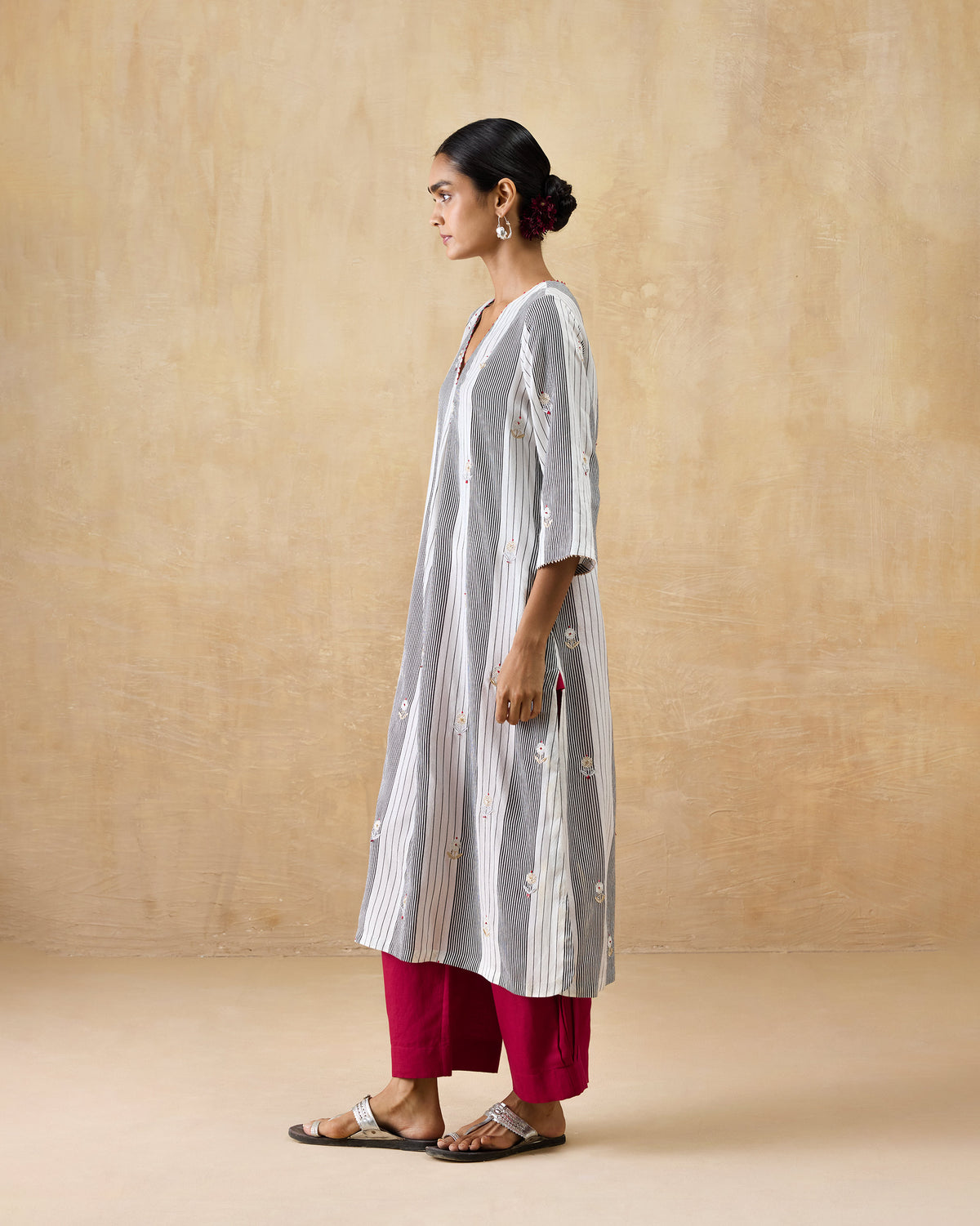 Side view of a black and ivory striped Dash Kurta with floral embroidery.
