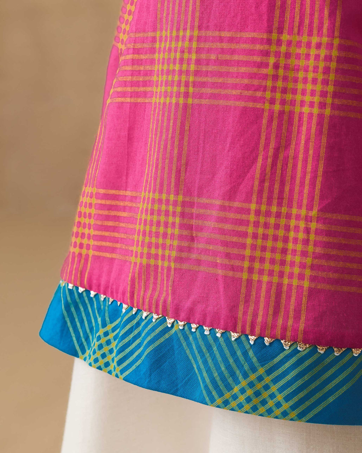 Close-up of the turquoise check hem border on the Drifter kurta.