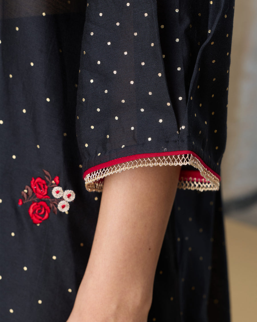 Close-up of the sleeve of the Moonbeam Kurta, with dense gold foil dots and twisted loop lace at the hem.