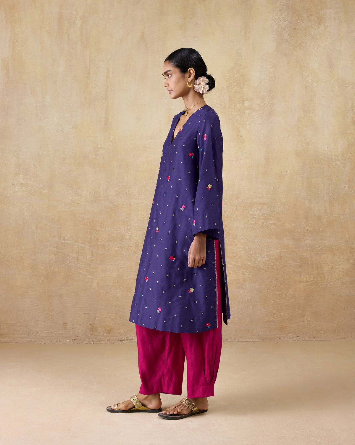 Side view of a purple embroidered Nebula kurta with side slits.