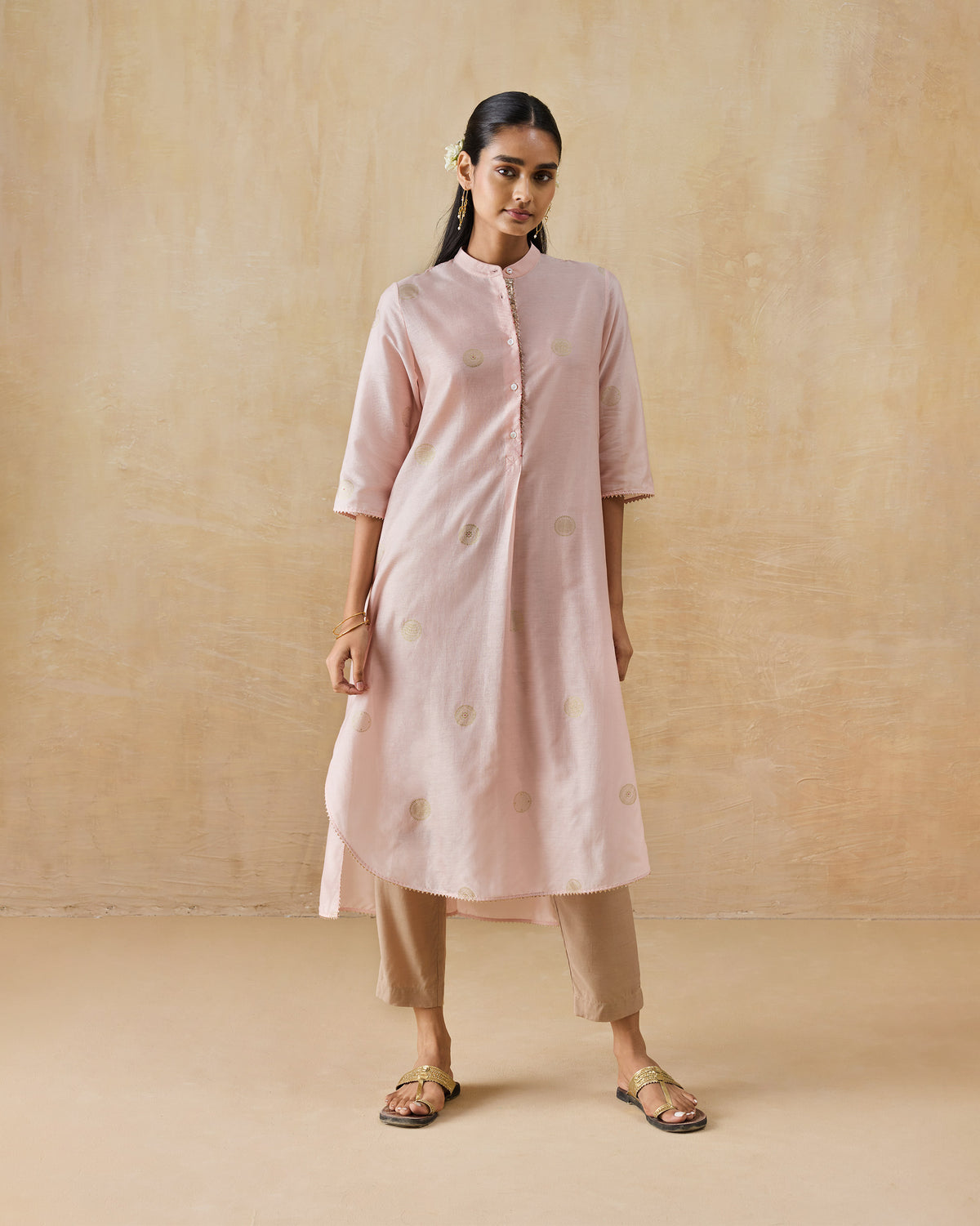 Person wearing a soft pink Radiant kurta with gold Asharfi dots.