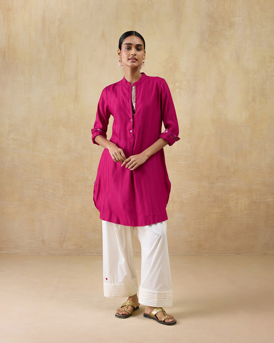 The Basic Mid Length Kurta worn over ivory Numa Pants with the cuffs rolled.