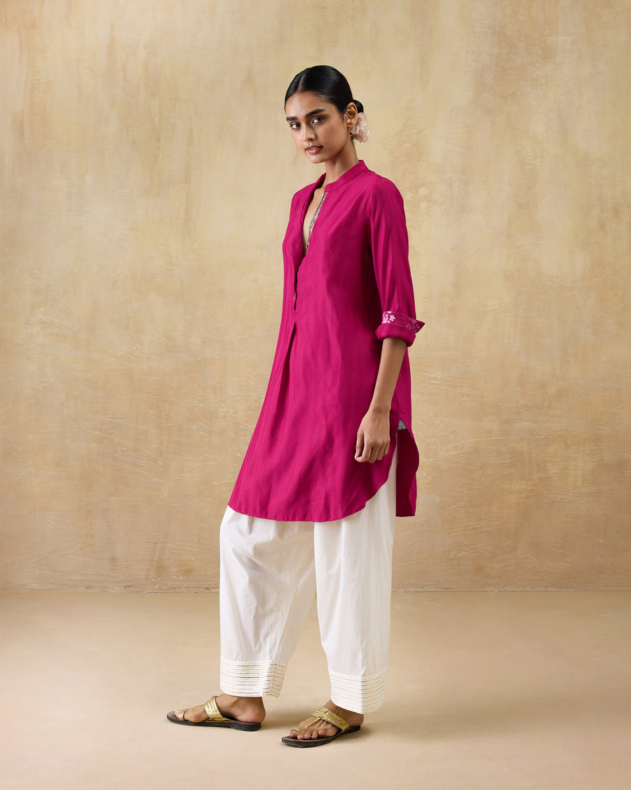 The Basic Mid Length Kurta seen from the side with flat sandals.