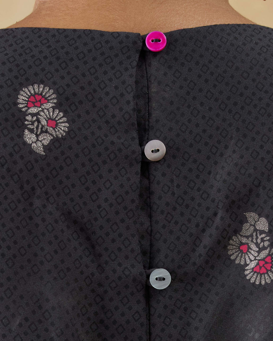 Close-up of the buttons down the centre back of the Bash Jumpsuit.