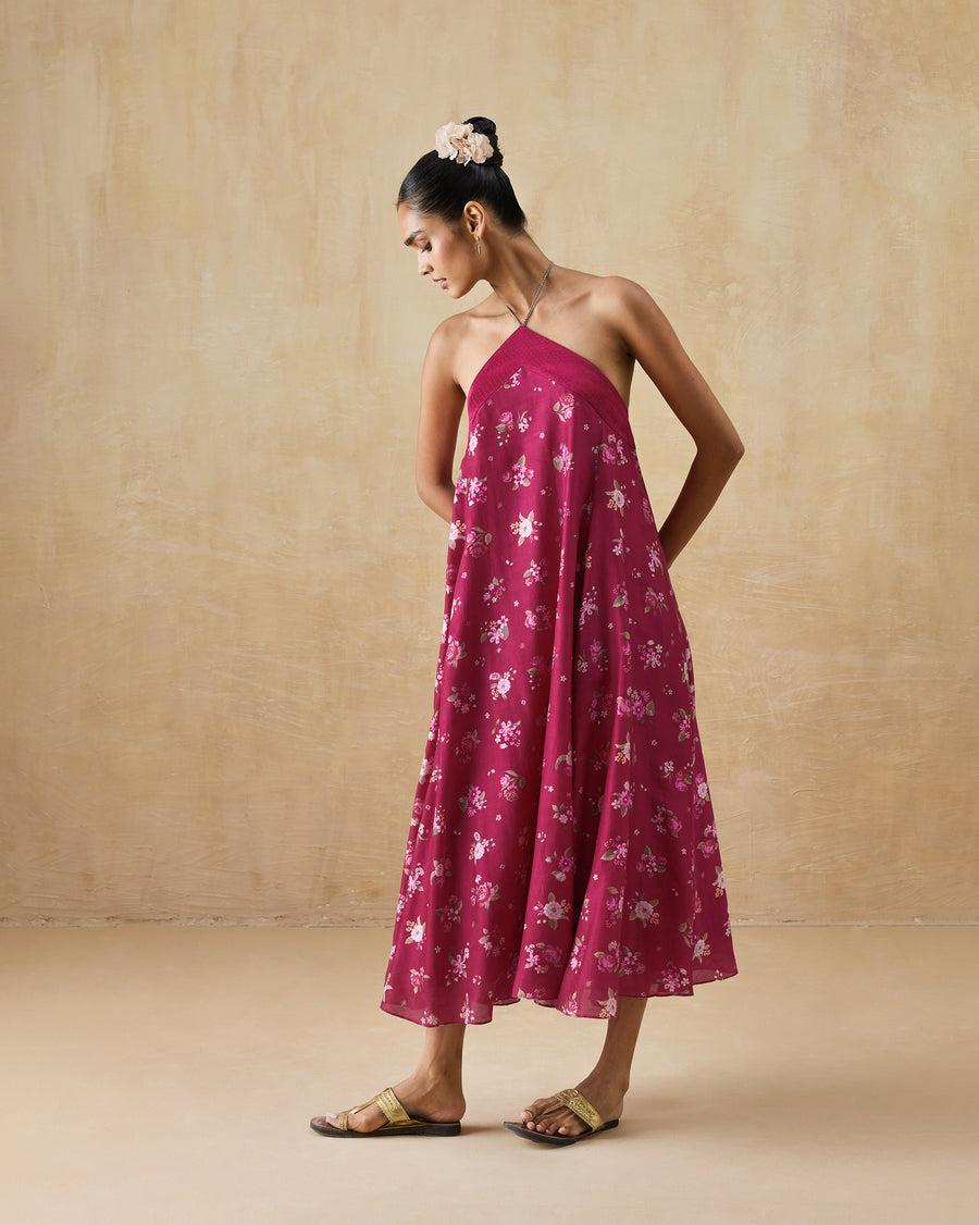 The Lumen Dress, a long berry pink printed cotton silk dress with a halter neckline and an A-line shape.
