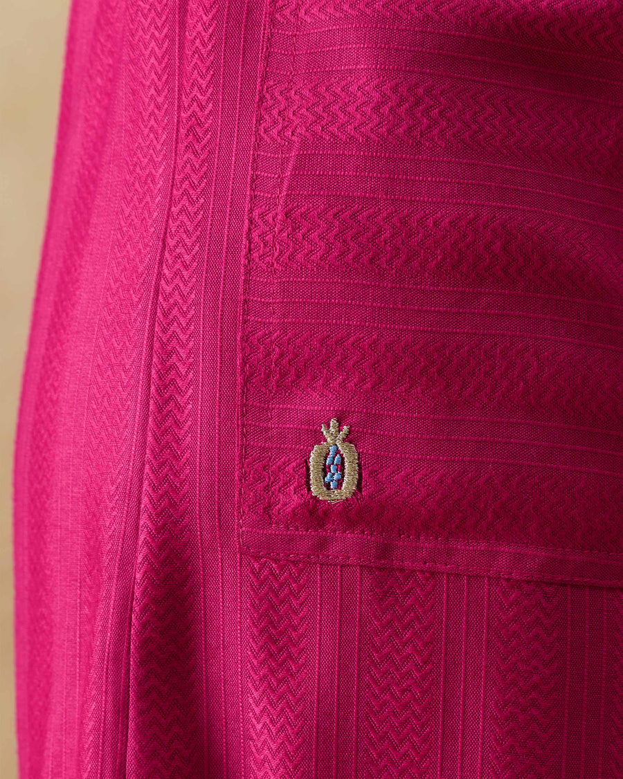 Close-up of the front pocket of the Serene Pants, with a gold anar embroidered at its corner on chevron stripes.