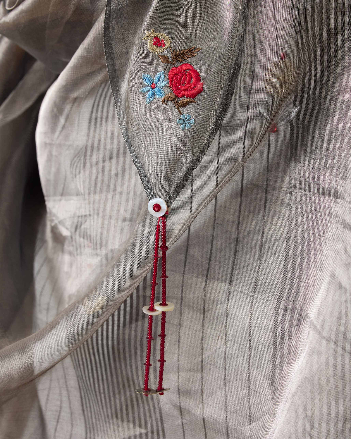 Close-up of Aluva Dupatta showing red rose and blue flower embroidery.
