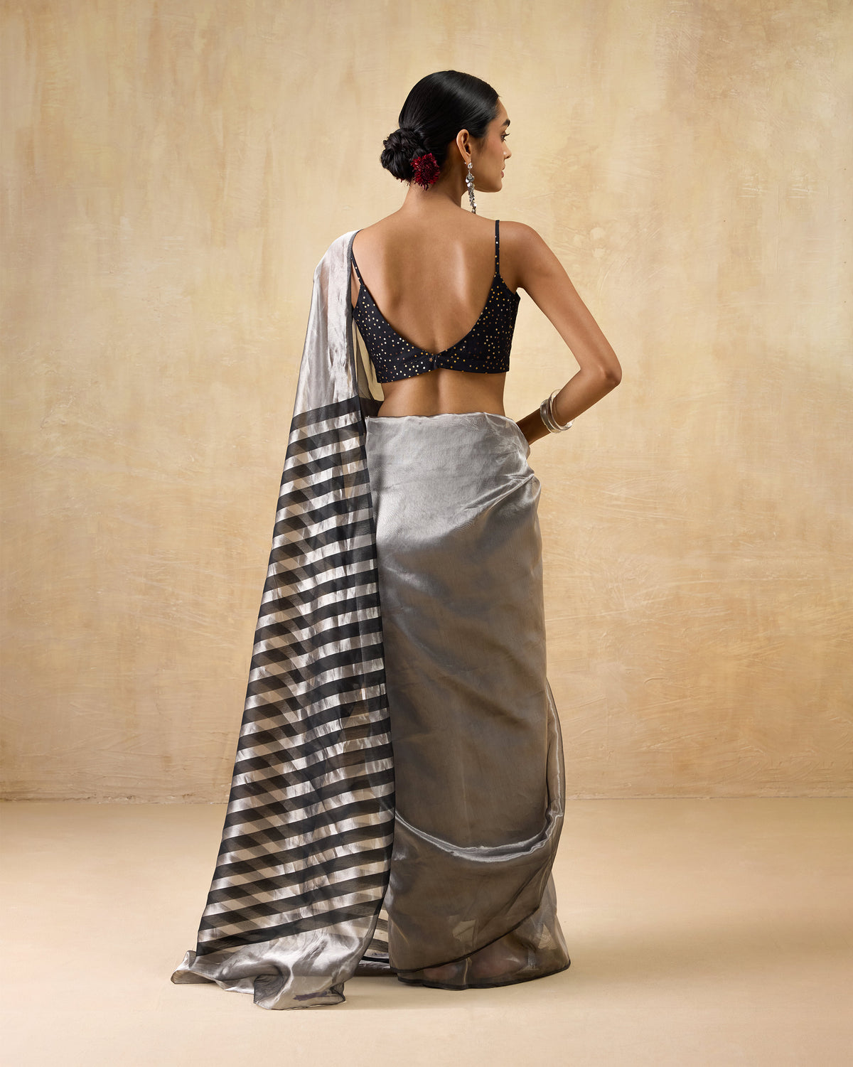 Back of a silver Party Stripes sari with a black striped pallu over the shoulder.