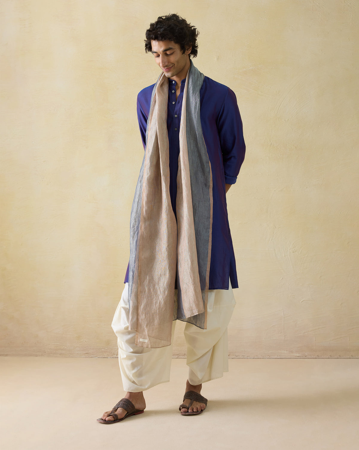 Person wearing a dual-tone purple Naaz kurta with a striped scarf.