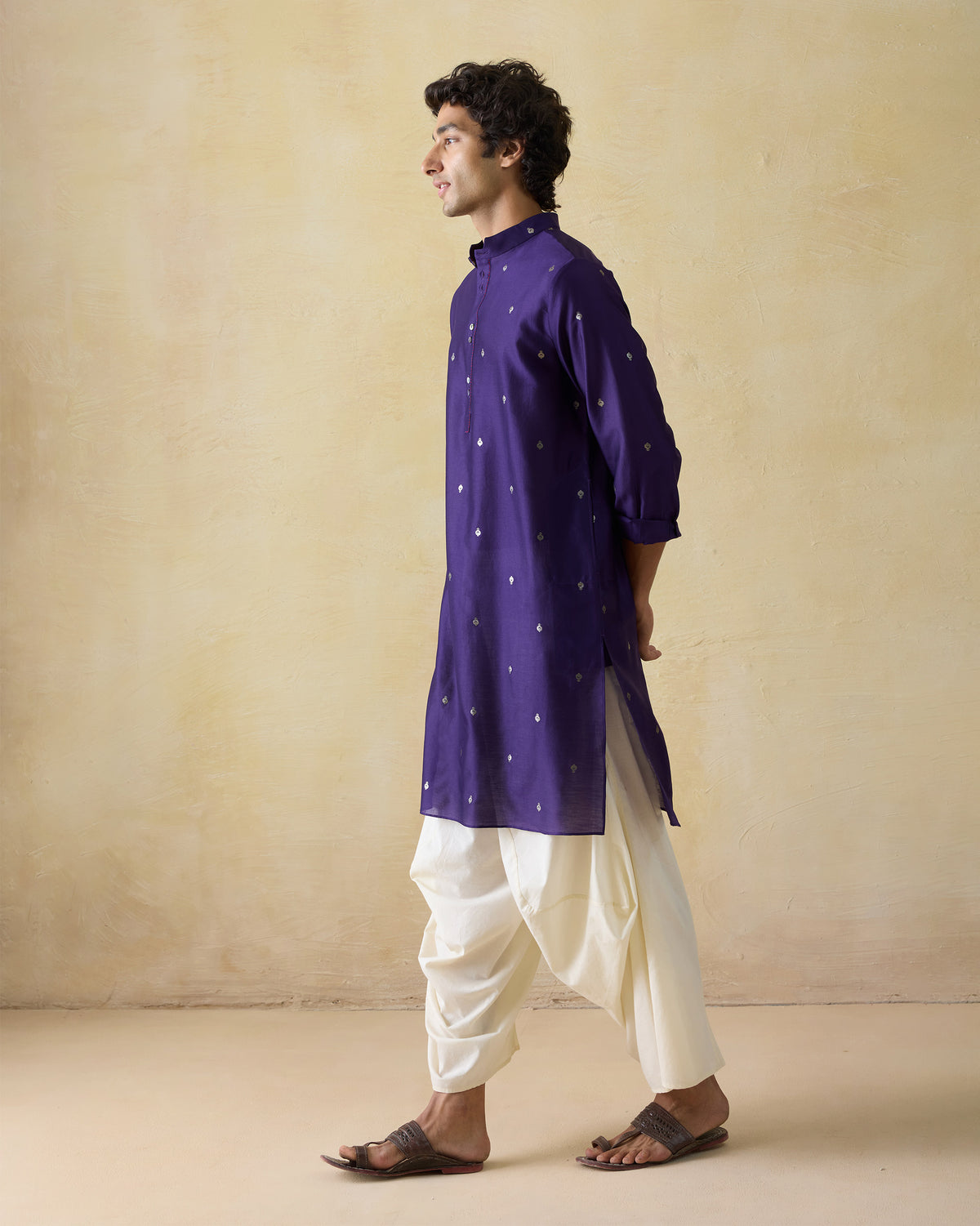 Side view of a dark purple Rey kurta with silver embroidery.