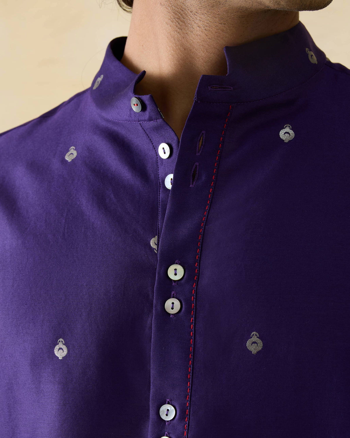 Close-up of a dark purple Rey kurta showing silver motifs and button placket.