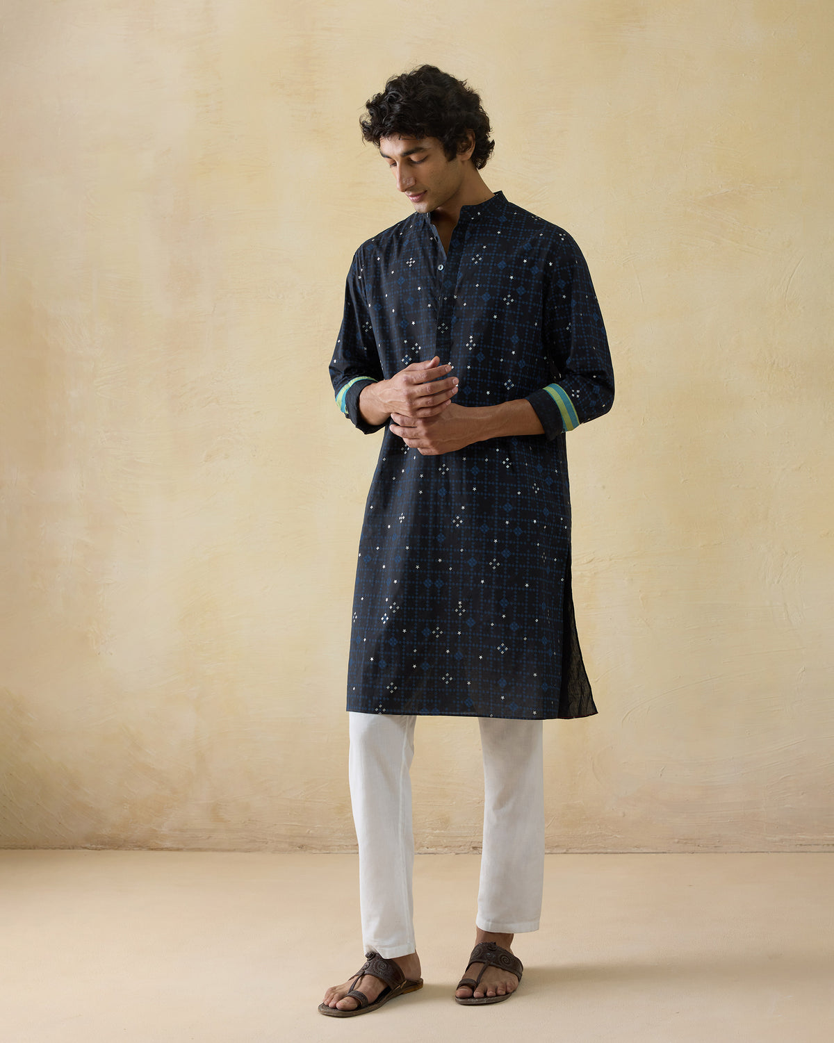Person wearing a dark navy Neckband Kurta with a geometric foil print.