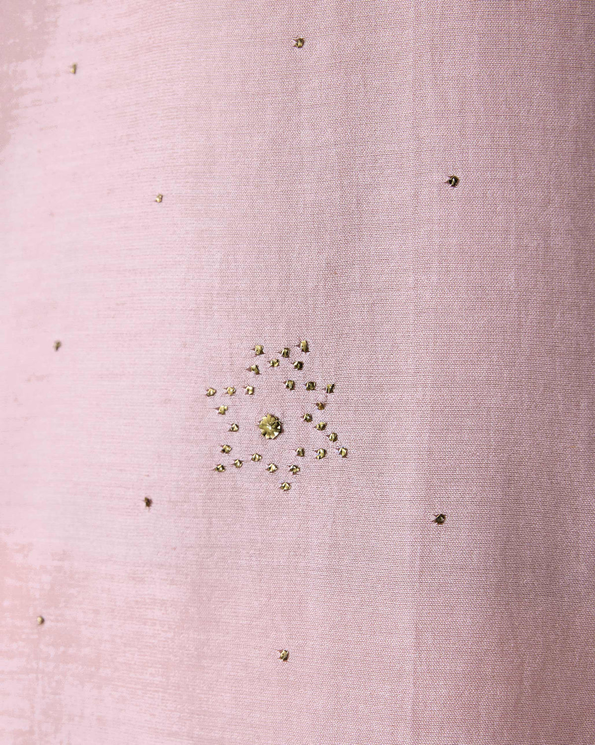 Close-up of mukaish stars on a light pink Arham kurta.