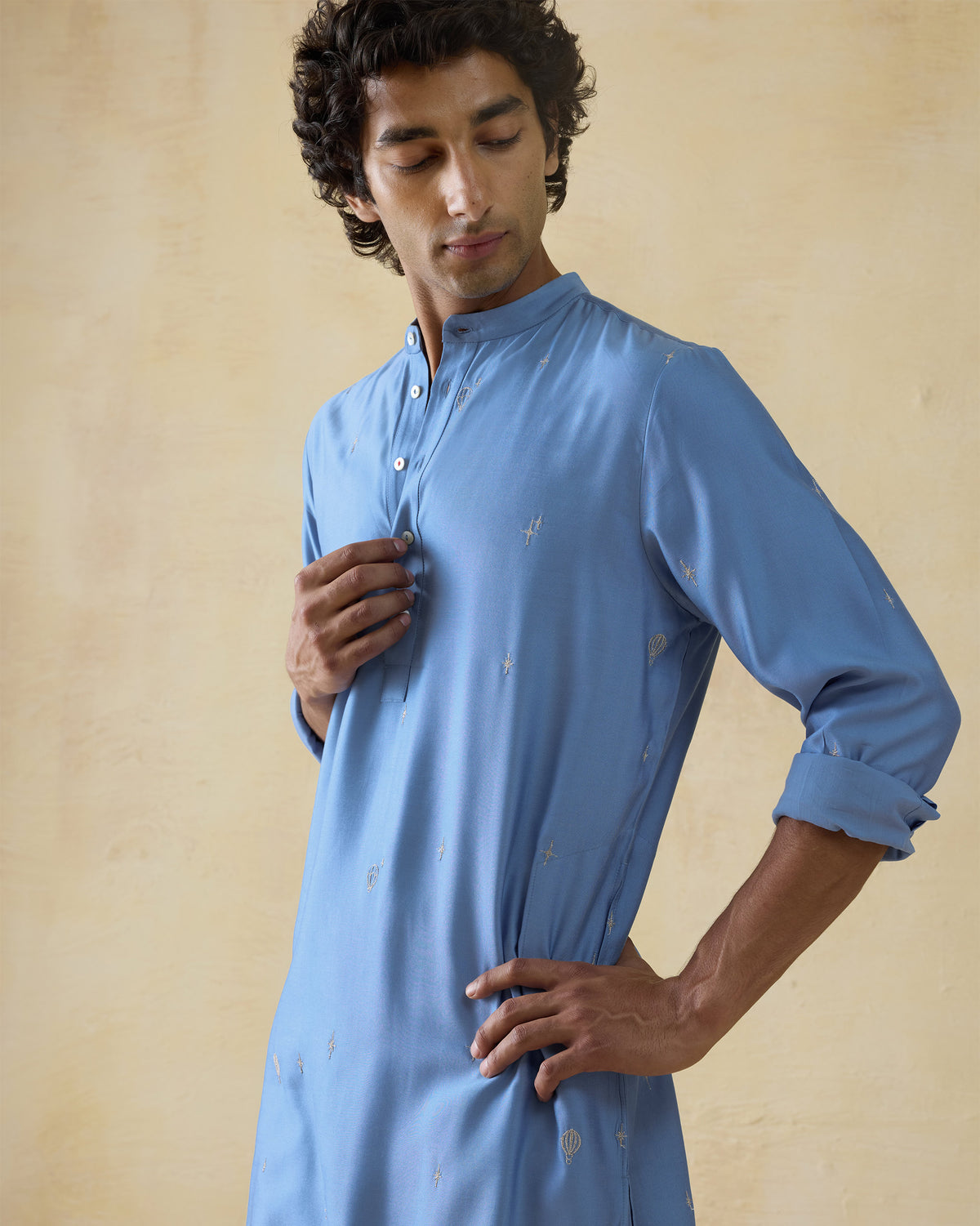 Light blue Bageecha kurta showing silver star and balloon embroidery.