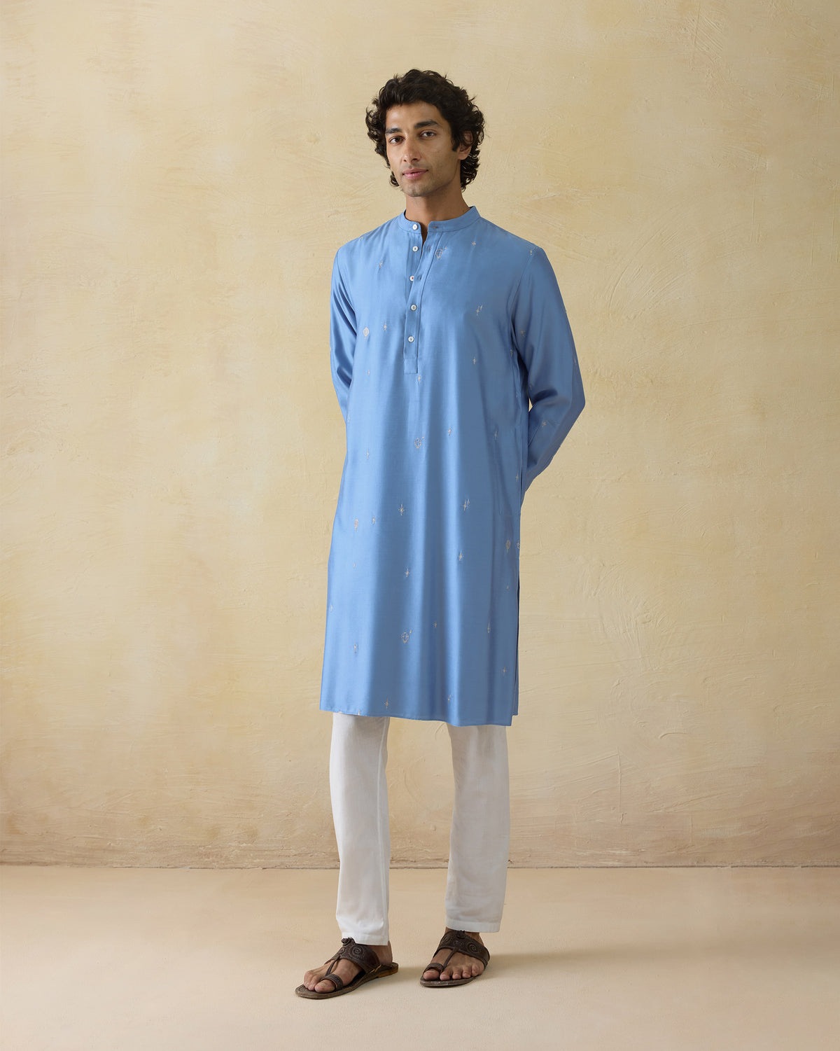 Person wearing a light blue Bageecha kurta with silver zari embroidery.