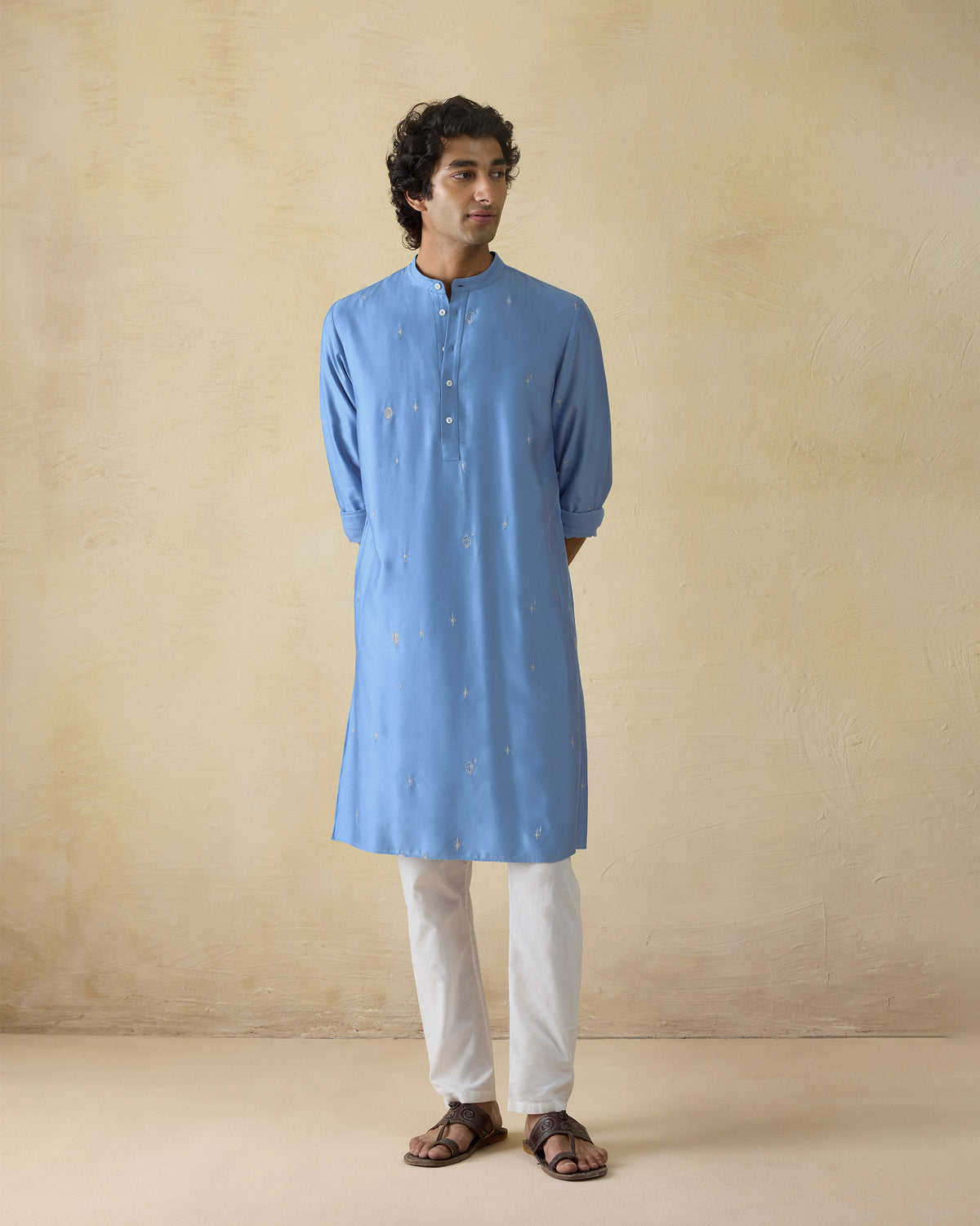 Person wearing a light blue Bageecha kurta with scattered silver embroidery.