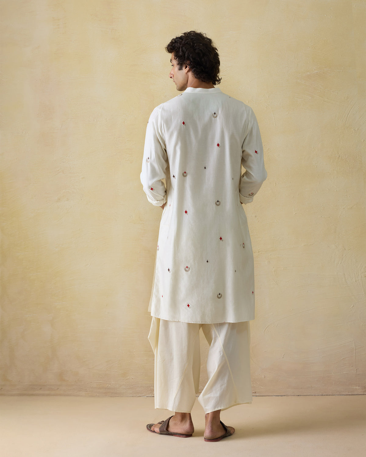 Back of an ivory Neckband Kurta with scattered red and silver embroidery.