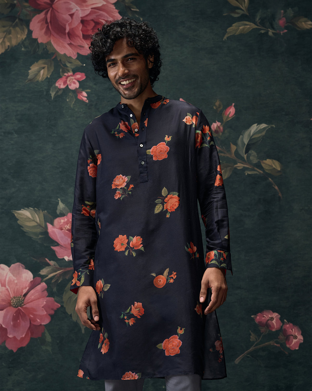 Person wearing a charcoal Ibn kurta with orange floral print.