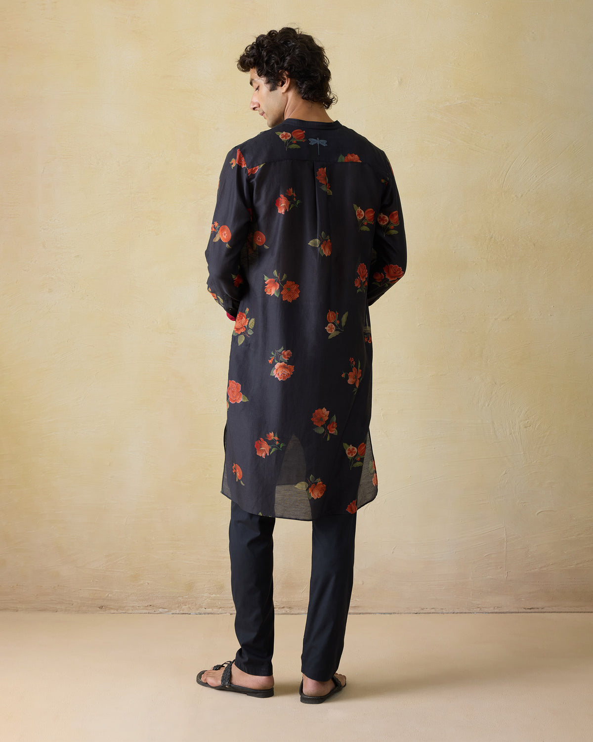 Back of a charcoal Ibn kurta with floral print and a blue dragonfly.