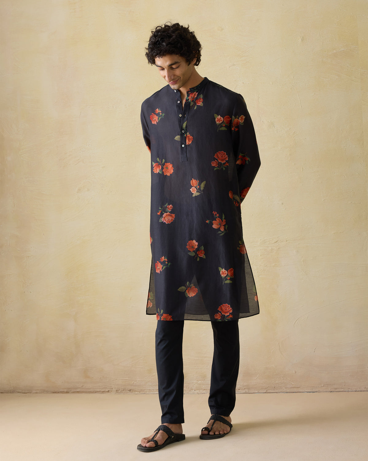 Person wearing a charcoal Ibn kurta with orange floral print.