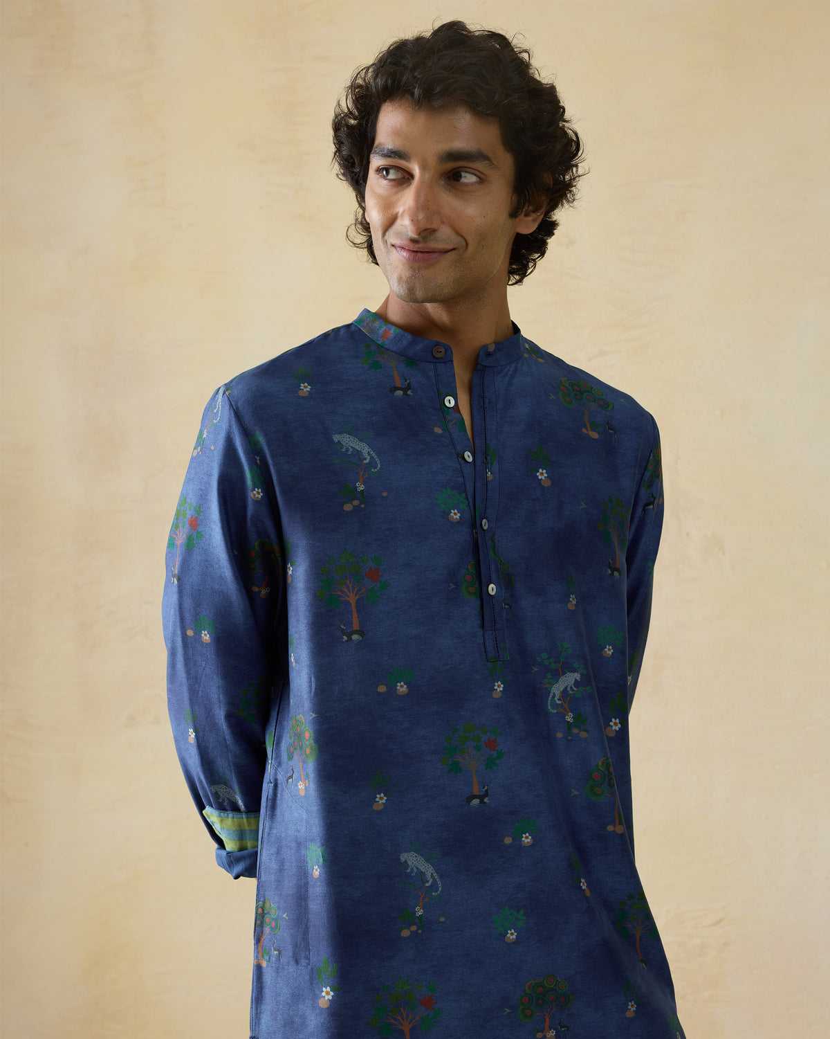 Person wearing a teal blue Astral kurta with a valley tree print.
