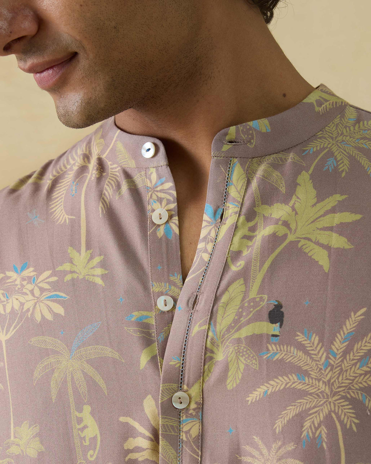 Close-up of a Chandni Chowk Kurta showing tropical palm print and ladder-stitched placket.