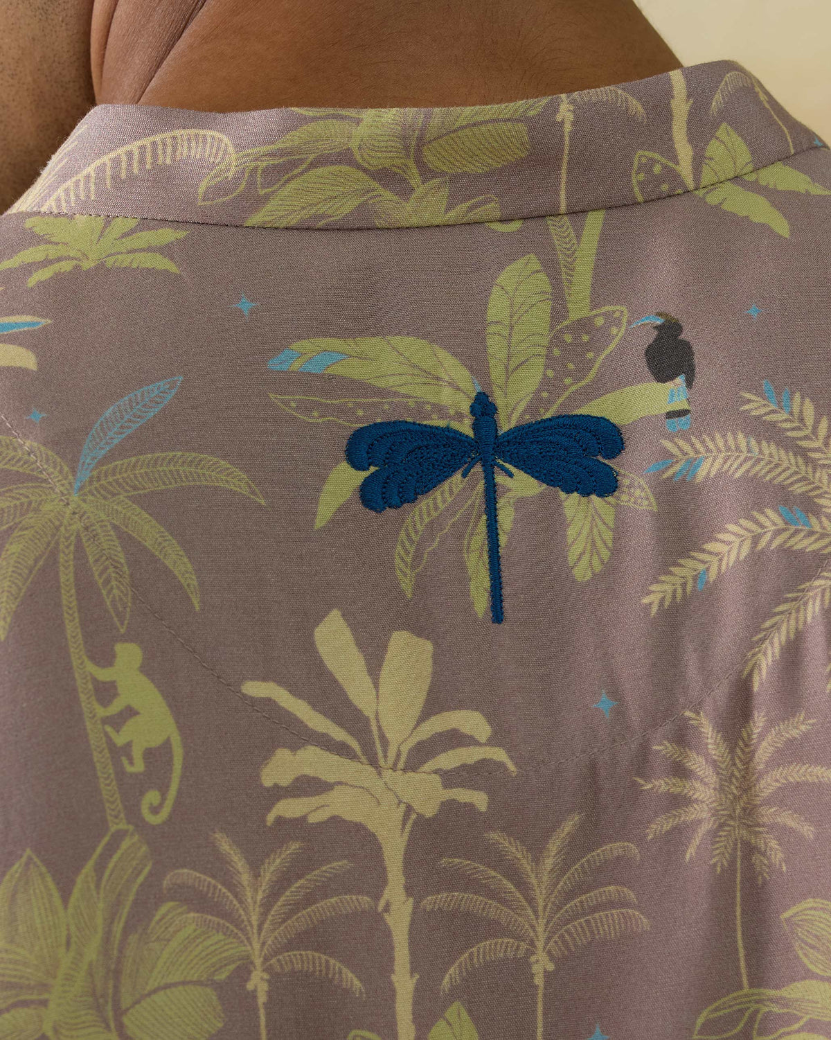 Close-up of the blue embroidered dragonfly on the back of a Chandni Chowk Kurta.