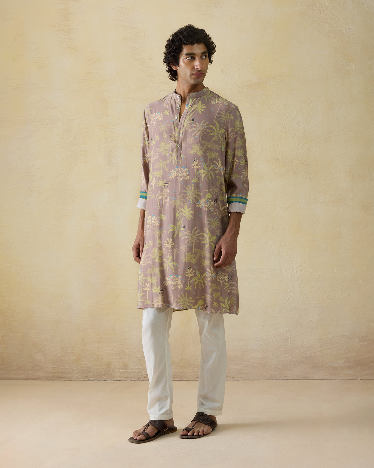 Person wearing a mauve Chandni Chowk Kurta with an all-over tropical palm print.