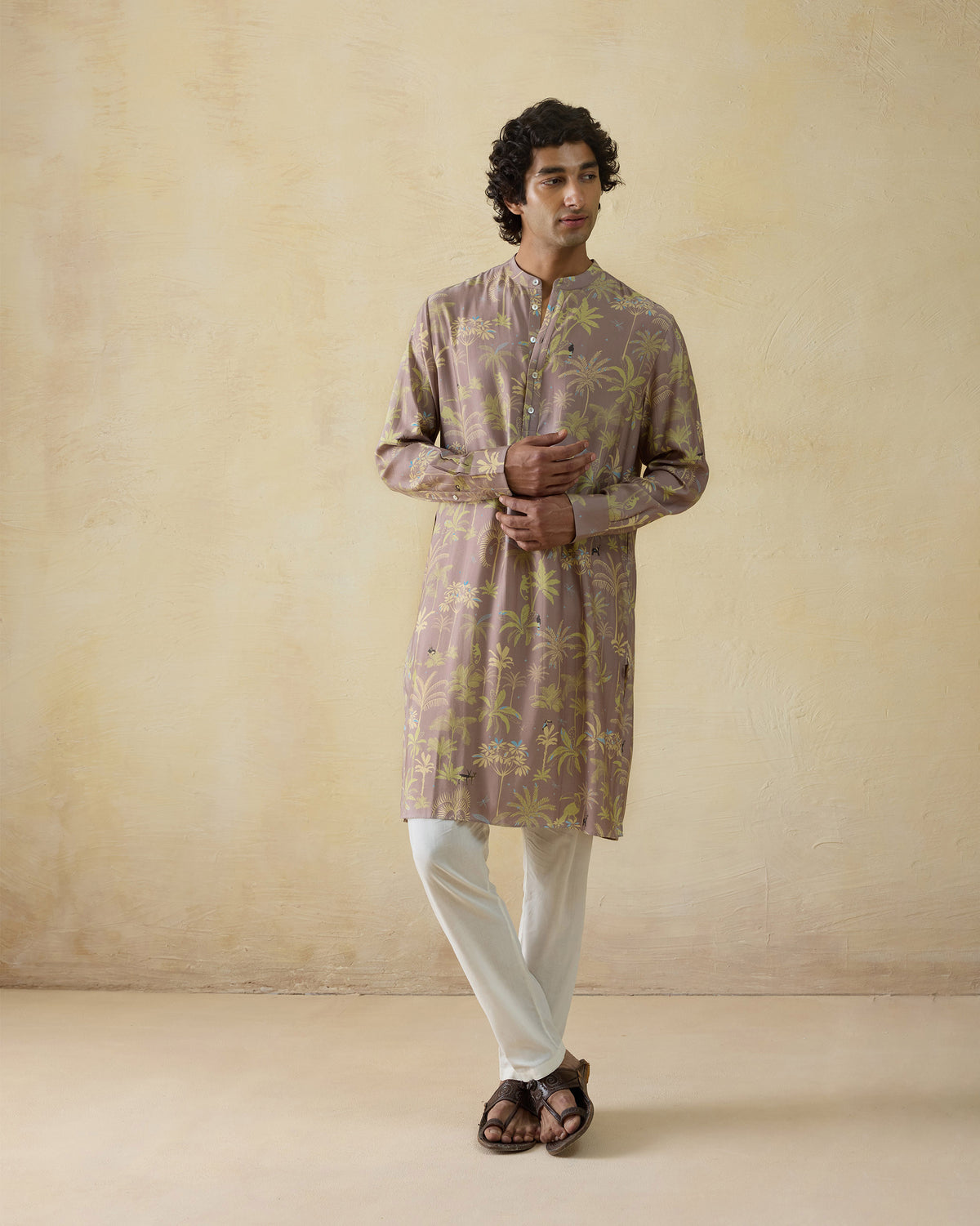Person wearing a mauve Chandni Chowk Kurta with a tropical palm print and mandarin collar.