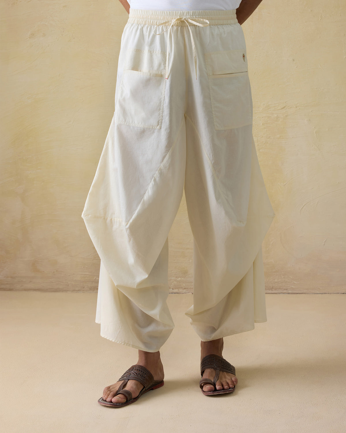 Ivory Tahir pants with a draped fit and front patch pockets.