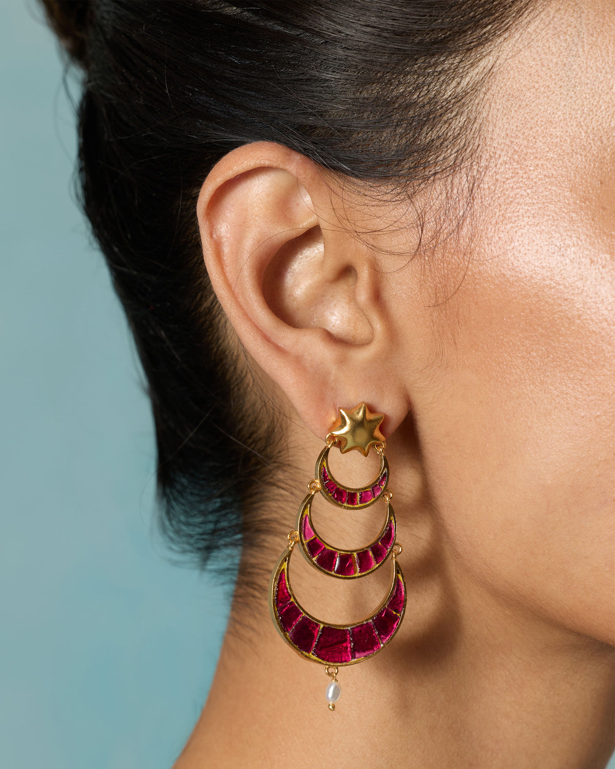 Close-up of a Gul-Chand Earring worn on an ear, showing pink stone crescents.