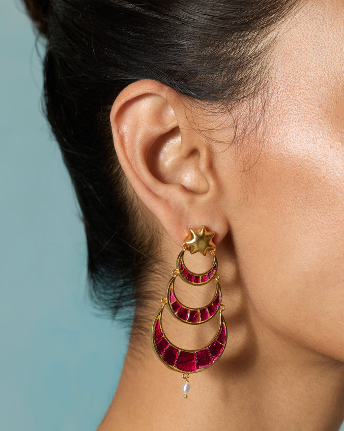 Close-up of a Gul-Chand Earring worn on an ear, showing pink stone crescents.