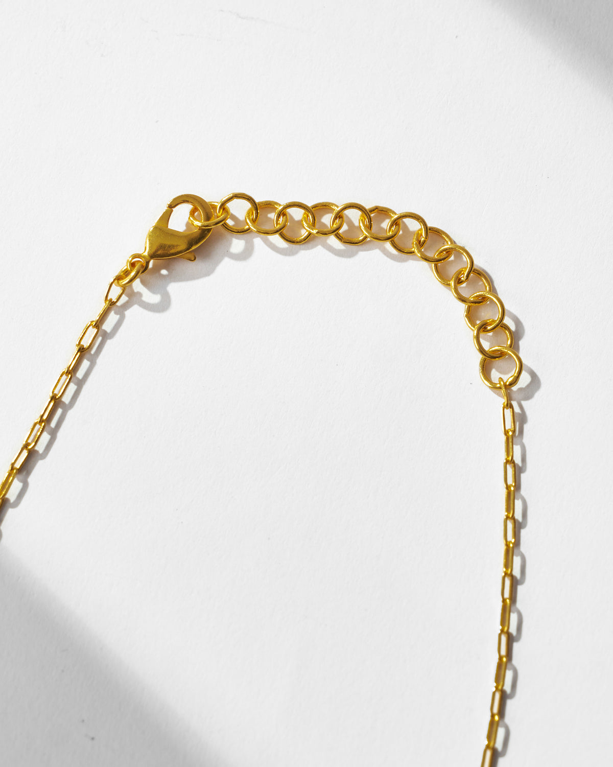 Close-up of the gold clasp and extender chain on the Anar Bagicha necklace.