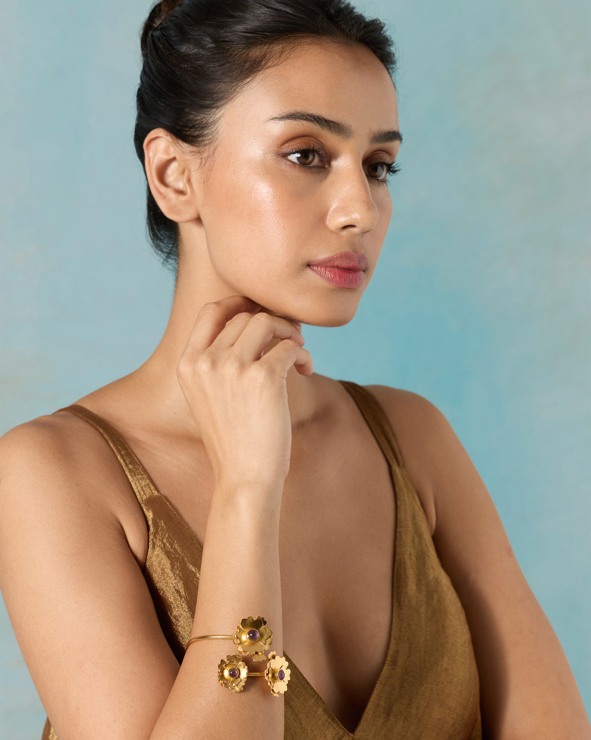 Upper body of a person wearing a Kesar Phool Cuff on the wrist.
