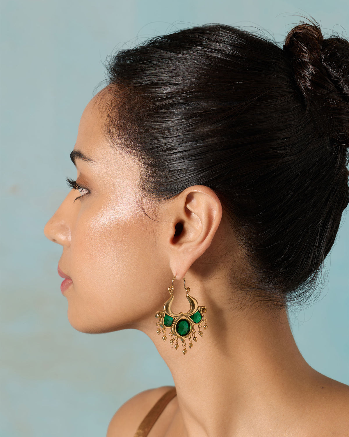 Side profile of a person wearing a Darbaar Bali earring.