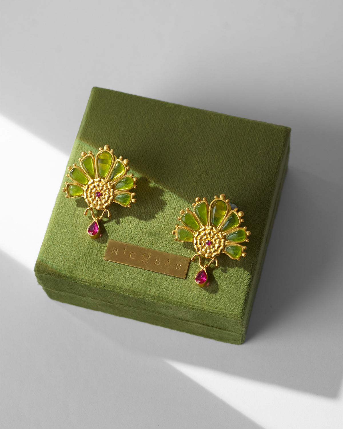 Mari-Palm earrings on a green Nicobar box.