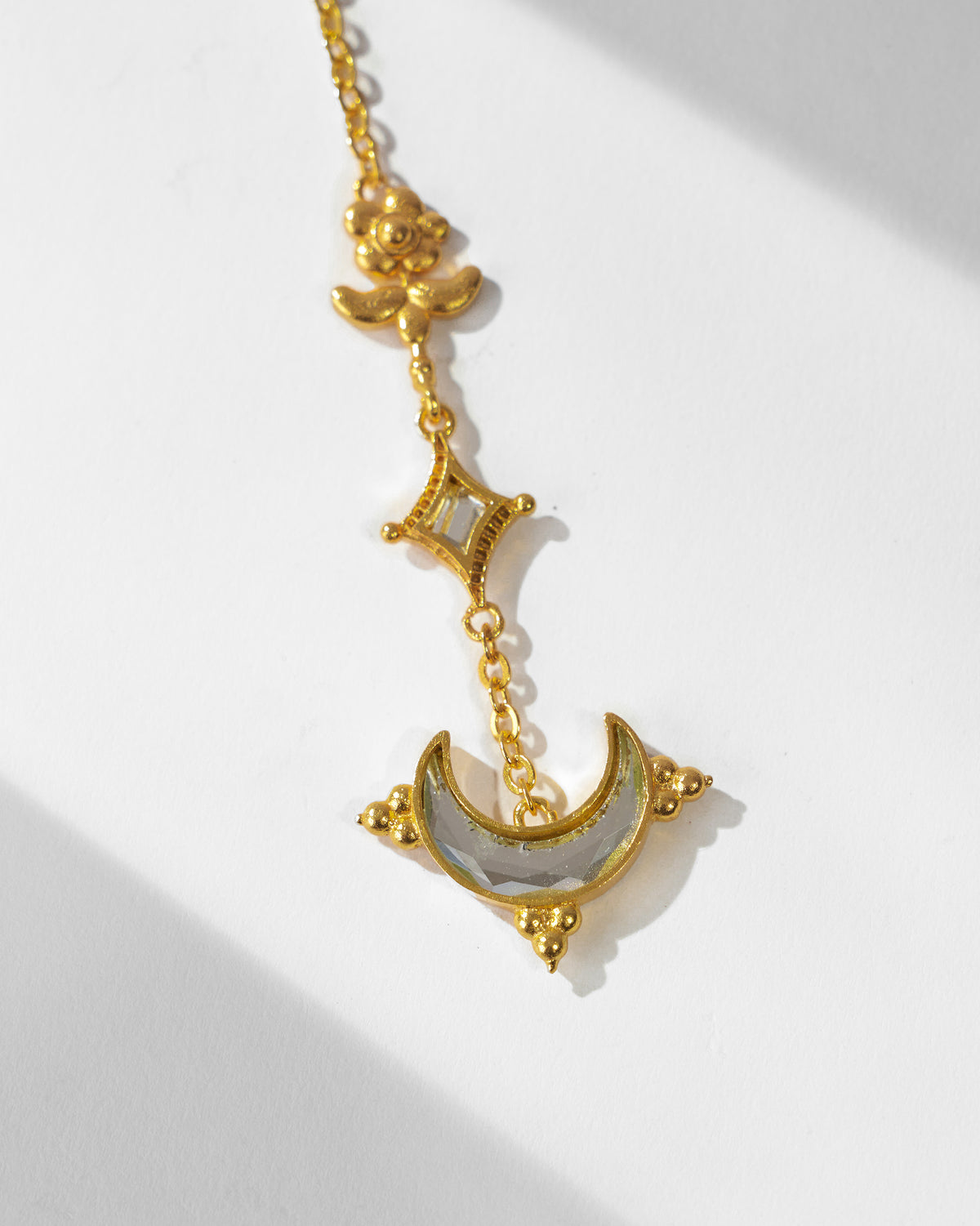 Close-up of the Chand maangtika flower, diamond and crescent mirror drop.